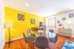 a dining room with a glass table and chairs at GuestReady - Sunshine Belém in Lisbon