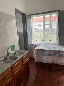 a kitchen with a sink and a window at Santa Cruz das Flores in Lajes das Flores