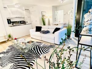 a living room with a zebra rug and a white couch at Luxury Suite Koksijde 310 - Adults only in Koksijde