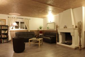 a living room with two couches and a fireplace at La Maison Vésubie in Roquebillière