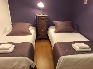 a room with two beds and a dresser with towels at La Maison Vésubie in Roquebillière +17 photos