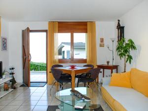 a living room with a couch and a table at Apartment Lakeview La Marea by Interhome in Piazzogna