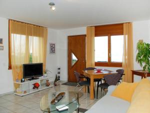 a living room with a couch and a table at Apartment Lakeview La Marea by Interhome in Piazzogna