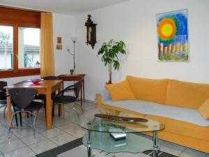 a living room with a couch and a table at Apartment Lakeview La Marea by Interhome in Piazzogna +6 photos