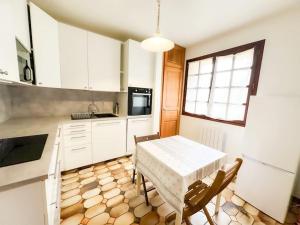 a kitchen with a table and chairs in a kitchen at Anh Dao-Disneyland-Parking Gratuite et Terrasse in Champs-Sur-Marne