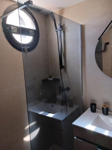 a bathroom with a shower and a sink and a mirror at Apartamento SMILE Complex Amaya Fuerteventura in Costa de Antigua