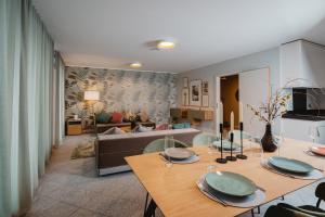 a living room with a table and a couch at 21rooms Apartments in Ingolstadt