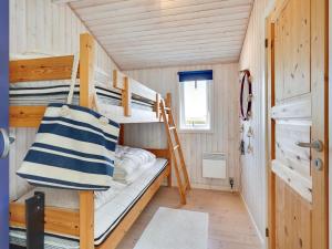 a bedroom with bunk beds in a tiny house at Holiday Home Dragan - 250m from the sea by Interhome in Sæby +10 photos