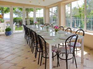 a long table in a room with windows at Holiday Home Ca Romeu by Interhome in Alcover