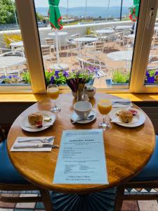 a table with plates of food and glasses of orange juice at An Cruiscin Lan in Spiddal