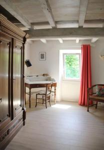 a living room with a table and a window at La Maison de Berthe - Havre de paix dans la campagne - Entièrement rénovée et équipéé in Montmaur