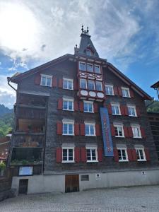 a large building with red windows and a tower at Romantikhus in Brand