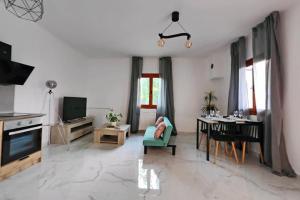 a living room with a green couch and a table at Village Villa, Agios Georgios Grevena in Grevena