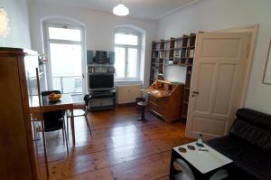 a living room with a couch and a table at Neustadtperle in Dresden