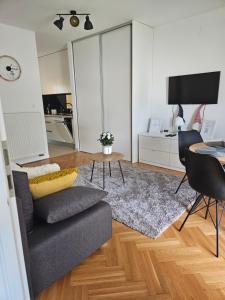 a living room with a couch and a table at Mali Raj - self check in in Osijek
