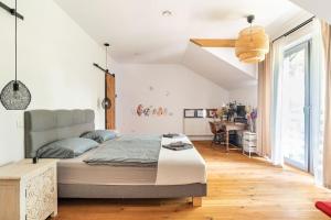 a bedroom with a large bed and a desk at Parkowa Garden in Michałowice
