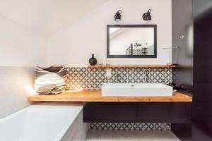 a bathroom with a sink and a mirror on a counter at Parkowa Garden in Michałowice +50 photos