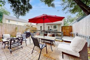 a patio with a table and chairs and an umbrella at Windy Harbor House in Wilmington