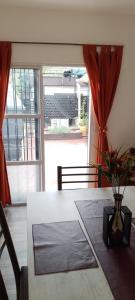 a dining room table with a vase with a plant on it at Señor Aconcagua in Godoy Cruz