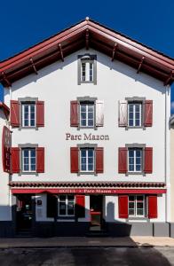 a large white building with red shuttered windows at H&ocirc;tel Parc Mazon-Biarritz in Biarritz