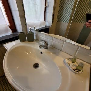a white sink in a bathroom with a mirror at Casa Anselmo Guest House in Pagani +56 photos