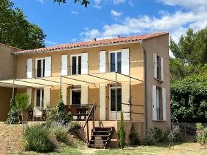 a large house with a porch and patio at Villa au lac du Salagou - 10 pers in Octon