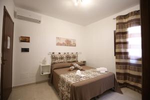 A bed or beds in a room at La Corte Dei Naviganti