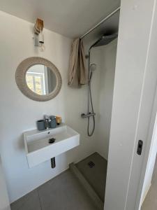 a bathroom with a sink and a mirror at Chic flat with terrace in Antiparos and sea view in Andiparos +39 photos