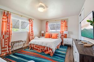 a bedroom with a bed with orange curtains and a desk at Eccentric home with pool tiki hut & outdoor kitchen in Pompano Beach +26 photos