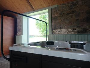 a bath tub in a bathroom with a window at Westfield Barn in Cashel +29 photos