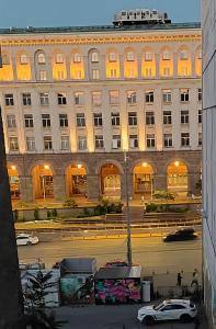 a large building with cars parked in front of it at La Casa di Sofia in Sofia