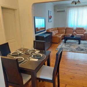 a living room with a table and a couch at La Casa di Sofia in Sofia