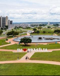 a park in a city with a sign that reads brasilia at Charmoso Duplex ao Lado da Torre de TV Brasília in Torto