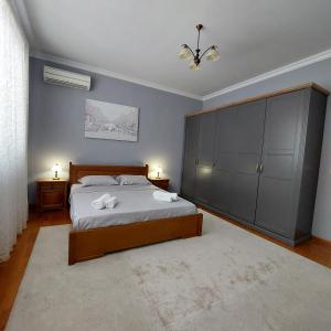 a bedroom with a bed and a large cabinet at La Casa di Sofia in Sofia +15 photos
