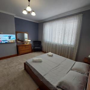 a bedroom with a bed and a window with a mirror at La Casa di Sofia in Sofia