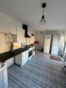 a kitchen with white appliances and a tile floor at apartamienty "Pozitiv" in Karolino-Buhaz +105 photos