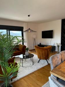 a living room with a couch and a tv at Sky hill residence Mostar in Mostar