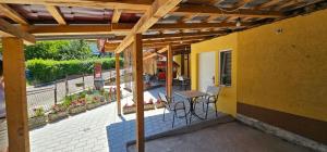 a patio with a table and chairs on a building at Dedovina in Soko Banja
