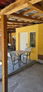 a table and chairs sitting under a building at Dedovina in Soko Banja