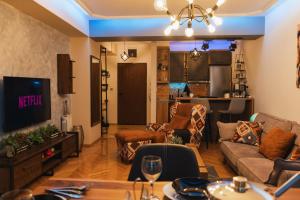 a living room with a couch and a tv at - All-Around Skopje Apartments - Premium Hospitality - in Skopje