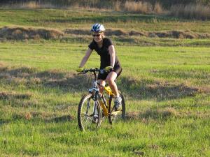 a person riding a bike in a field at Kings Grant Country Retreat in Ixopo