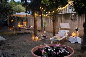 a garden with a table and chairs and lights at il Giardino in Civitanova Marche