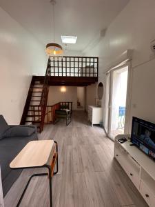 a living room with a couch and a tv at Provence Sweet Home in Manosque