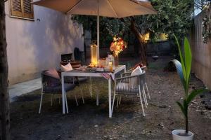 a table with chairs and an umbrella in a yard at il Giardino in Civitanova Marche