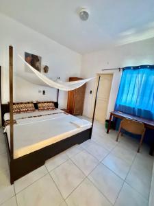 Postel nebo postele na pokoji v ubytování Guesthouse Cocotiers Cotonou