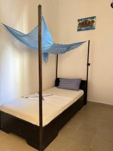 Postel nebo postele na pokoji v ubytování Guesthouse Cocotiers Cotonou
