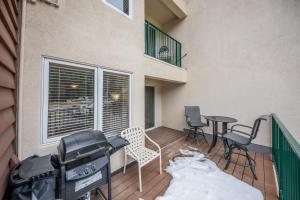 a balcony with a table and chairs and snow on the floor at Iron Horse Building C Unit 1023 in Winter Park +65 photos