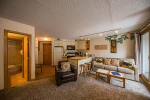 a living room with a couch and a kitchen at Iron Horse Building C Unit 1023 in Winter Park