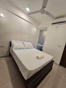 a large bed in a room with a ceiling at Secret Passage in Uswetakeiyawa +14 photos