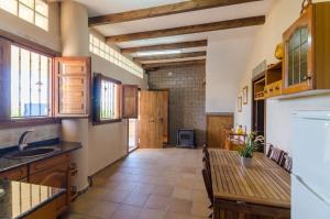 a kitchen with a table and a counter top at Club Villamar - Capriola 12 in Maçanet de la Selva